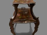 a small wooden table with a floral design on it