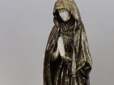 two figurines of a woman and a man with a dog