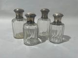 three glass salt and pepper shakers sitting on a white surface