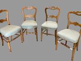 four antique chairs with upholstered backs and gold leaf trim