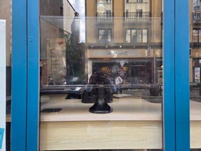 a statue of a man sitting on a table in a window