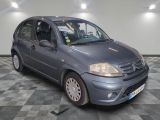 a picture of a small blue car parked in a garage