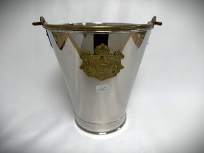 an antique silver ice bucket with a gold emblem on it