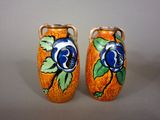 two vases with blue flowers painted on them