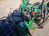 an image of a green tractor parked on the side of the road