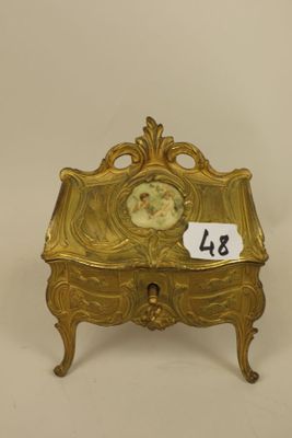 an antique brass box with a picture of a woman on it