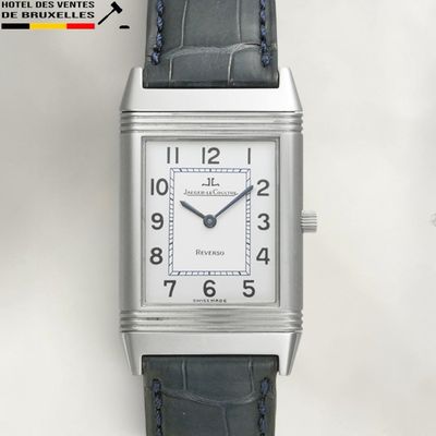 an image of a silver watch with a black leather strap