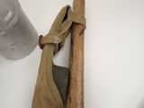 a baseball bat and a pair of shoes hanging on a wall