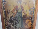 an old picture of a woman in a green dress on a wooden chair
