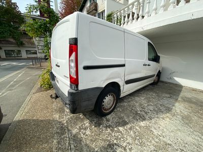 une camionnette blanche garée devant un bâtiment