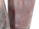 a pair of brown boots that are on a white surface