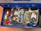 a blue box filled with assorted items on the floor