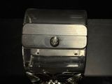 a silver box with a metal lid sitting on a table