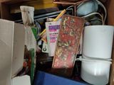 a cardboard box filled with various items and a book