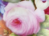 a close up of a vase with flowers painted on it