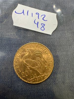 a close up of a gold coin with a label on it