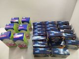several boxes of tea sit on a table next to a pile of tea bags