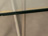 a close up of a glass table with metal legs