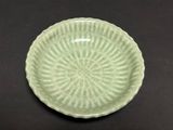 a green plate that has a circular design on it