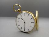 a gold pocket watch with roman numerals on the face