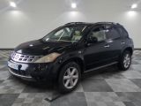 a picture of a black nissan suv parked in a garage