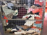 a metal cage filled with stuffed animals inside of it