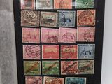 a black picture frame with a lot of stamps on it
