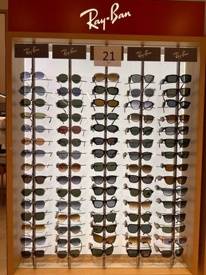 ray ban sunglasses are displayed in a display case in a store