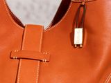 an orange purse with a padlock on the front of it