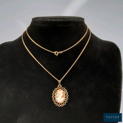 a gold necklace with a pearl pendant on a mannequin neck