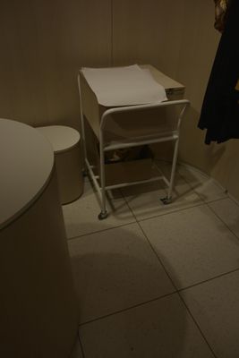 a small white table with a towel on it in a bathroom