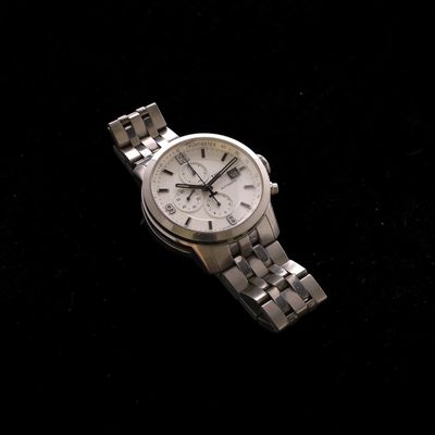 a close up of a watch on a black surface
