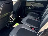 the back seats of a car are empty in a parking lot