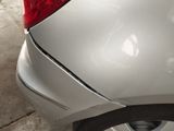 a close up of a car with a denting on the front of it