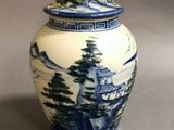 an image of a blue and white vase with a mountain scene on it