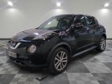 the black nissan juke suv is parked in the garage