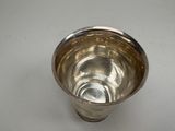 an image of a silver cup sitting on a white surface