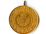 an image of a gold coin on a white surface with a blue cord