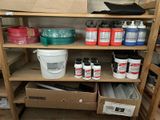 many cans of paint on a shelf in a room