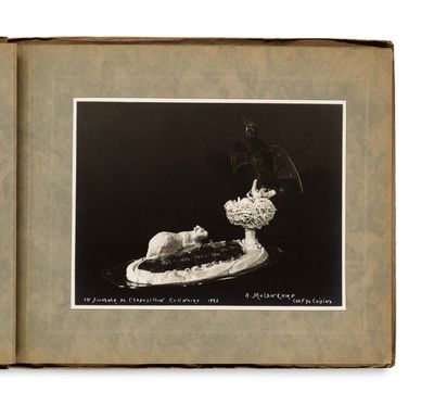 an old book with a picture of a cat and a plate of food