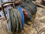 a picture of a reel and a hose in a garage
