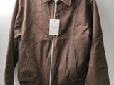 the jacket is hanging on a hanger on the wall