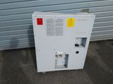 a white refrigerator with a red and yellow tag on it
