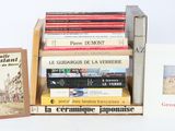 several books are stacked on top of each other on a table