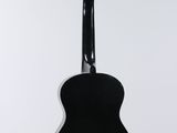 a close up of a guitar hanging from a string on a wall