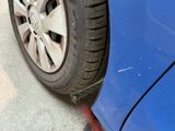 a close up of a tire on a blue car