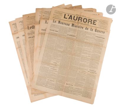 several newspapers are stacked on top of each other on a white surface