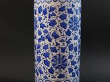 blue and white porcelain vase with floral design on a black background