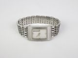 a close up of a wrist watch on a white surface