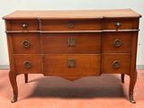an antique chest of drawers with a wooden top and metal handles